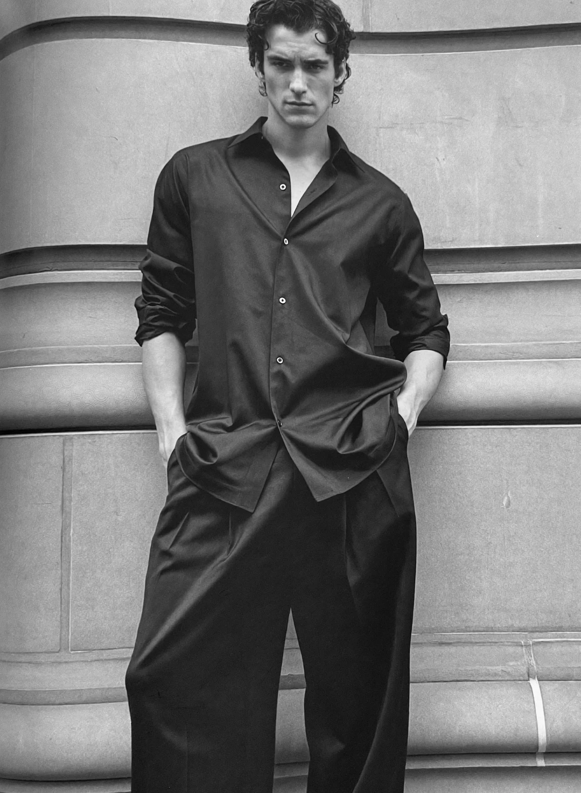 Menswear styling in a black shirt and tailored trousers
