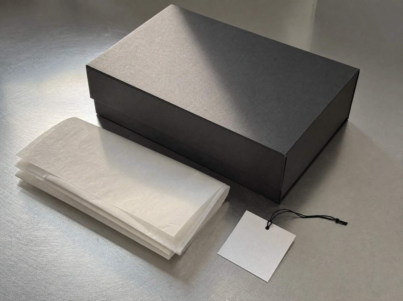 Charcoal packaging and tissue paper concept